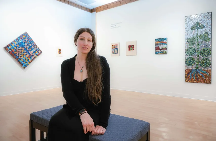 A woman sitting in an art gallery.